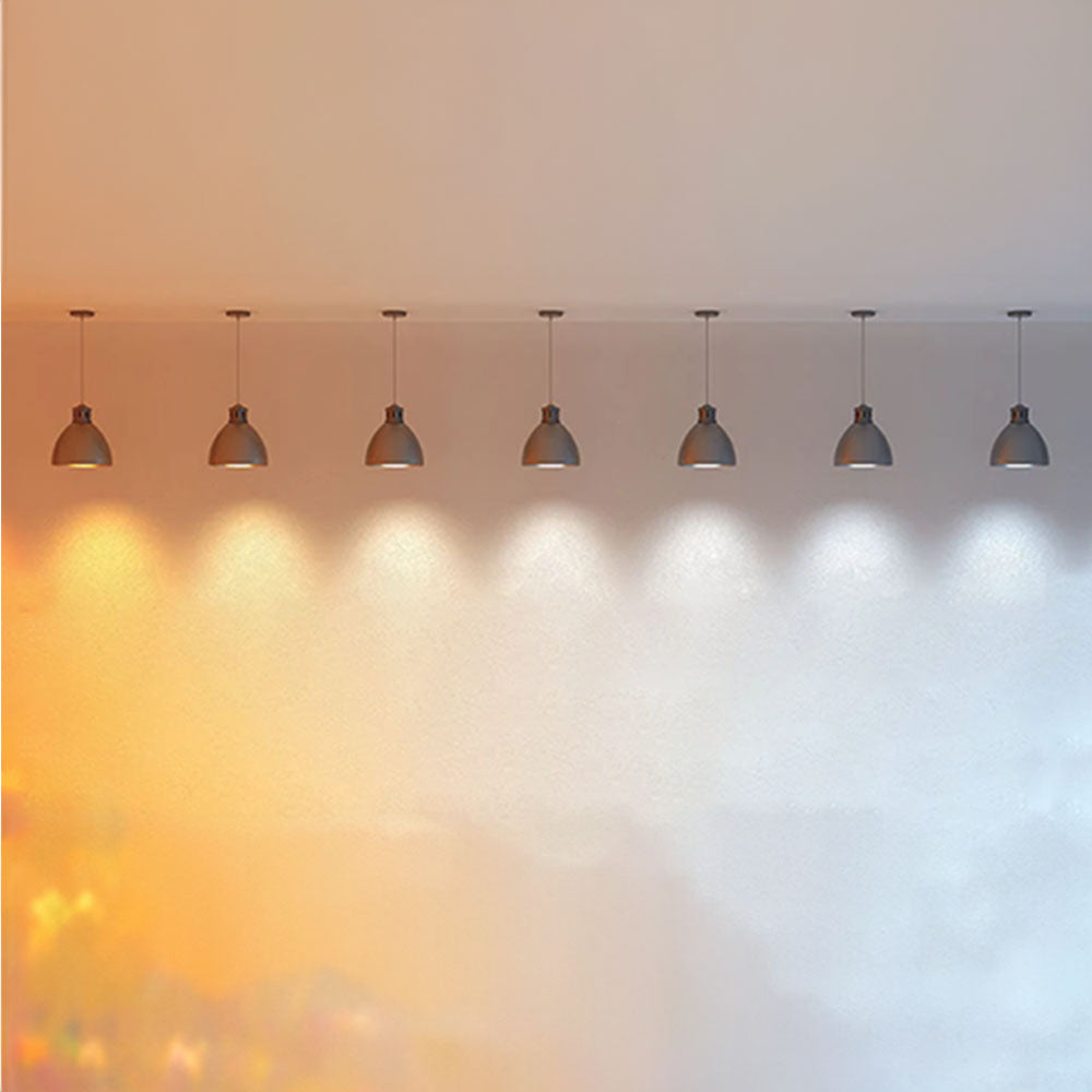Ceiling lamp shades placed in a line and showing different light temperatures