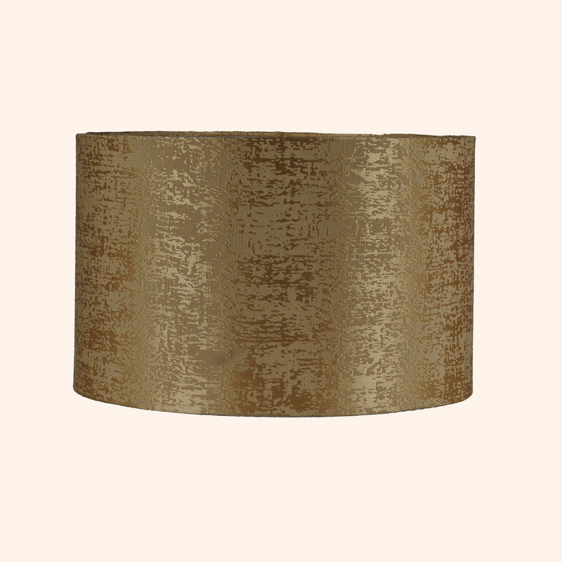 Drum shape lamp shade in golden color.