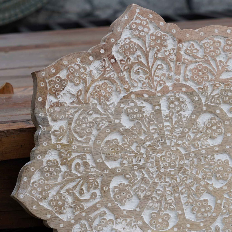 Zoomed image of traditional hand-carving on mango wood wall panel.