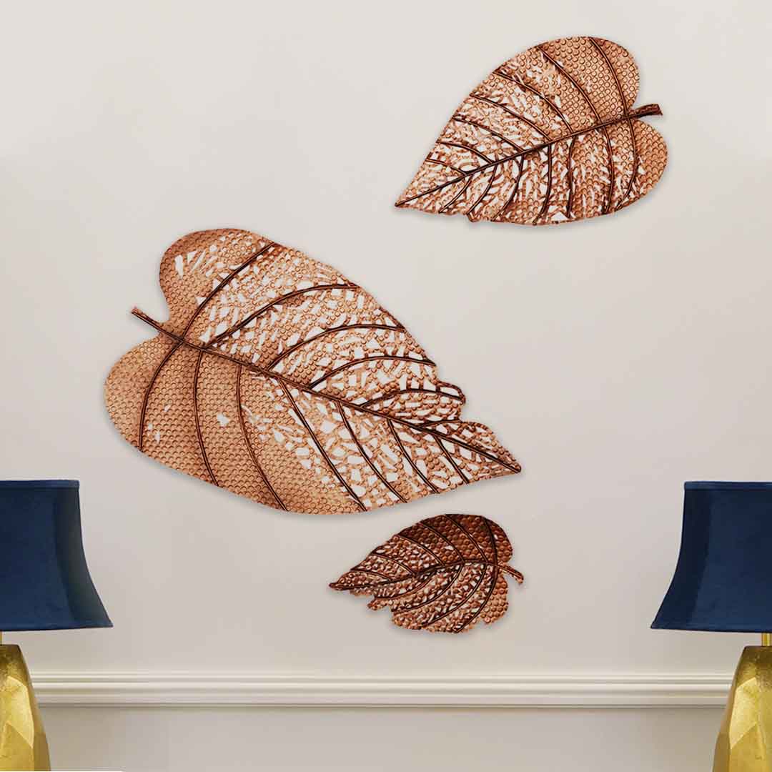 Set of 3 metallic leaves used as modern wall art.