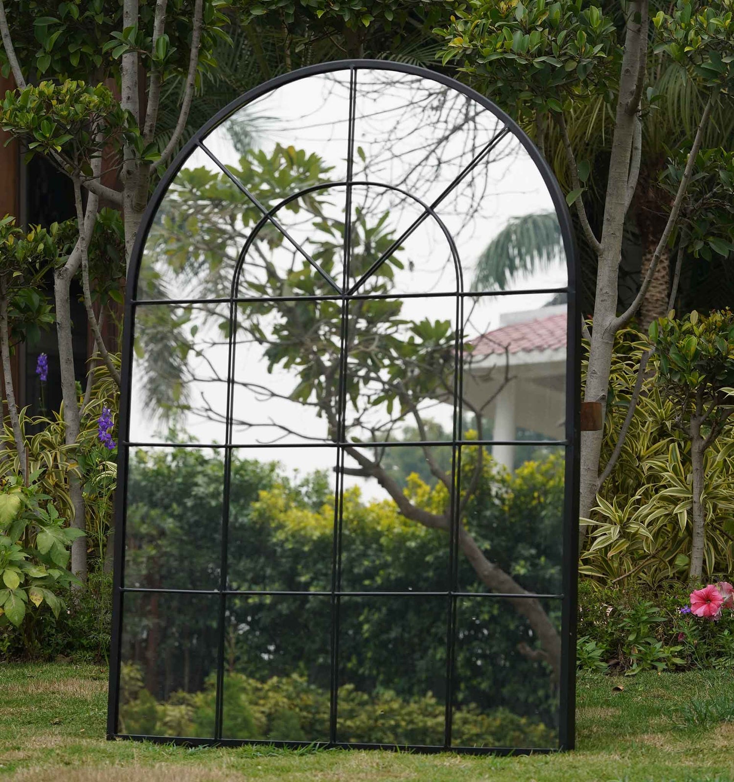 A large black metallic mirror shaped like a window close-up and front view