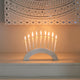 Front view of a white marble semi-circle slab as a candle holder with 9 slim candles.