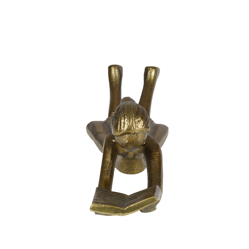 Table-top metallic decorative figurine with girl lying down and reading a book- front view.