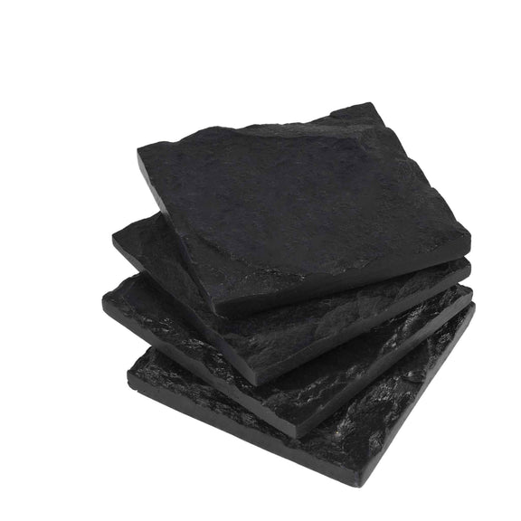 Four square shaped black slate stone coasters stacked on each other in a plain background.