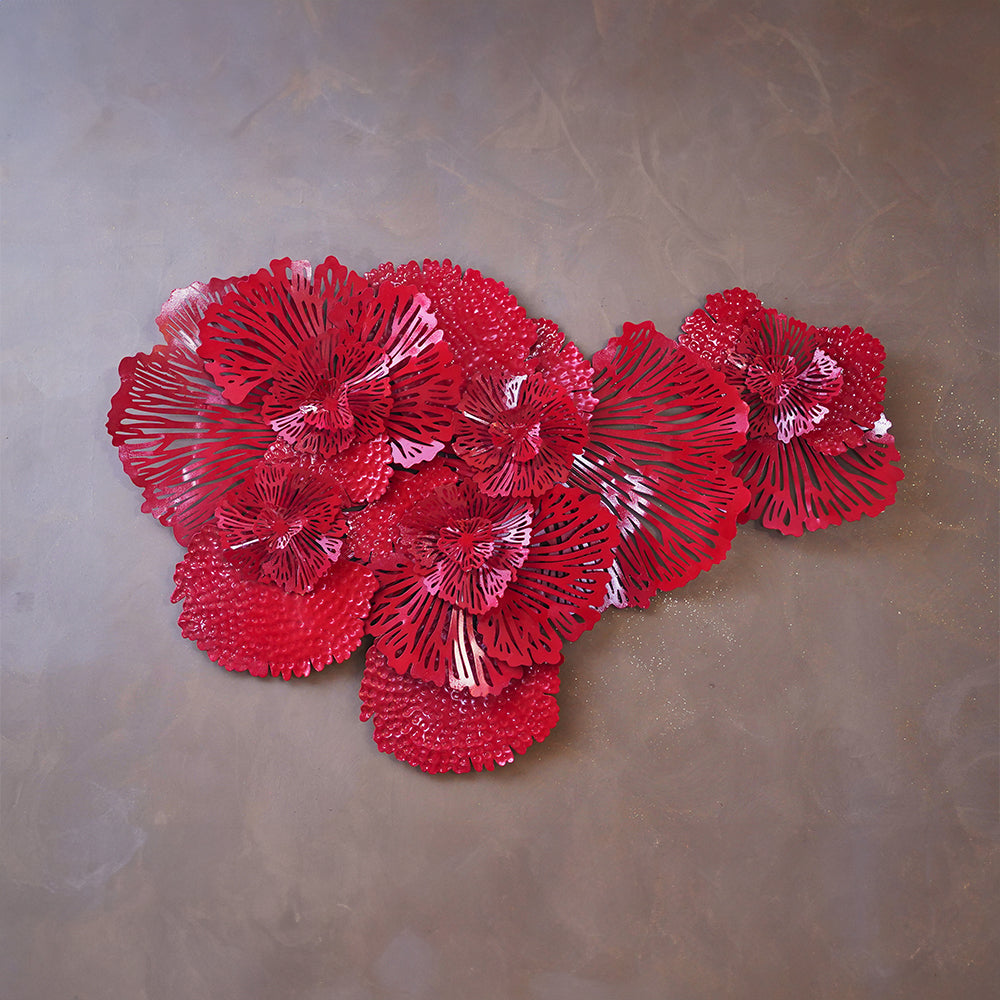 Close-up image of a red metallic wall art in the shape of a bouquet of flowers