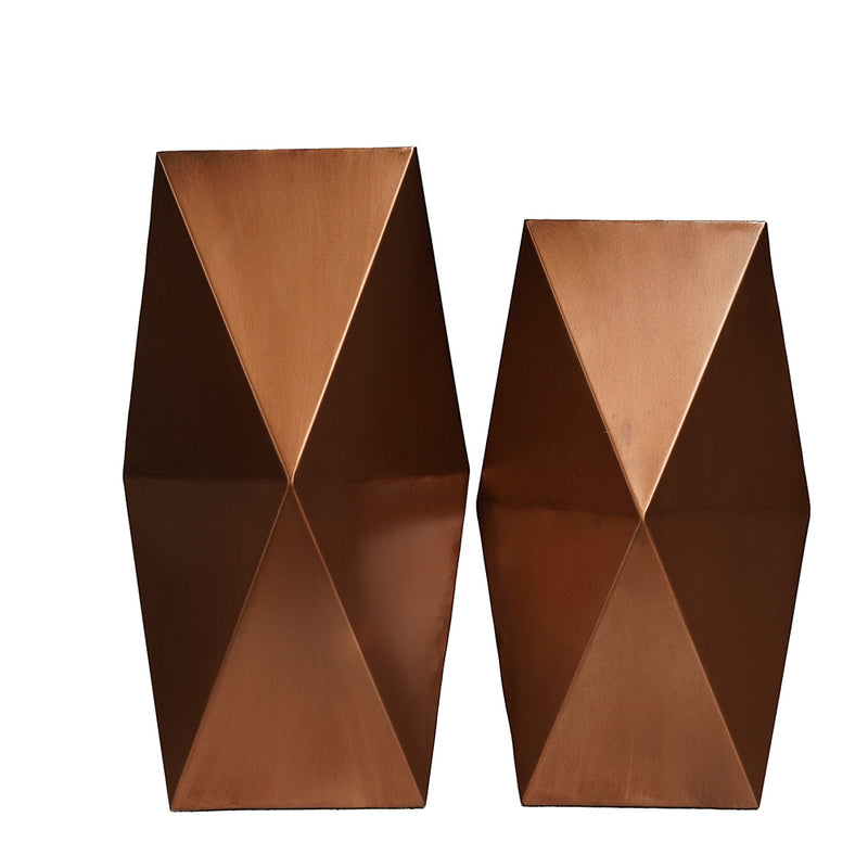 Two large hexagonal metallic vases in copper finish on a plain background.