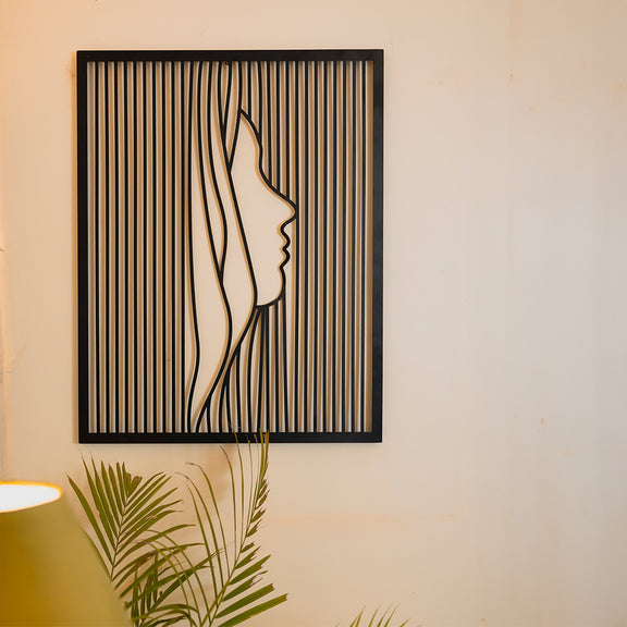 Large metallic black colored wall art showing  side face of a woman in modern abstract design.