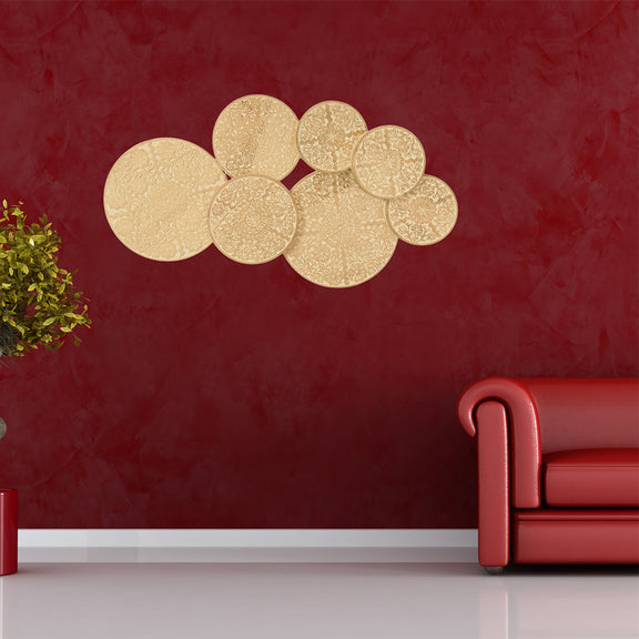 7  co-joined circular hand-carved mango wood panels displayed on a red wall of a modern living room.