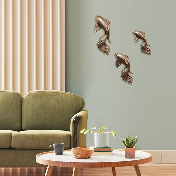 Set of 3 nickel chrome finish metallic wall art fish placed in a living room 