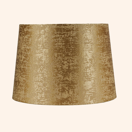 Tapered drum shape lamp shade in golden color.