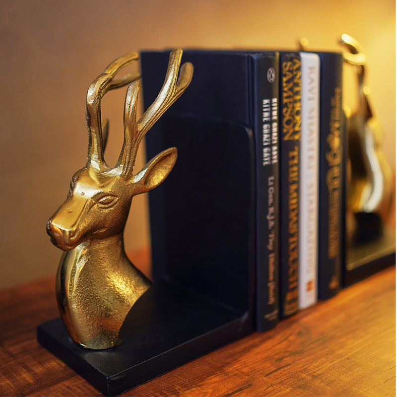 Bookends set of 2 in golden metallic deer head and antlers design with 4 books in between at a closeup side profile.