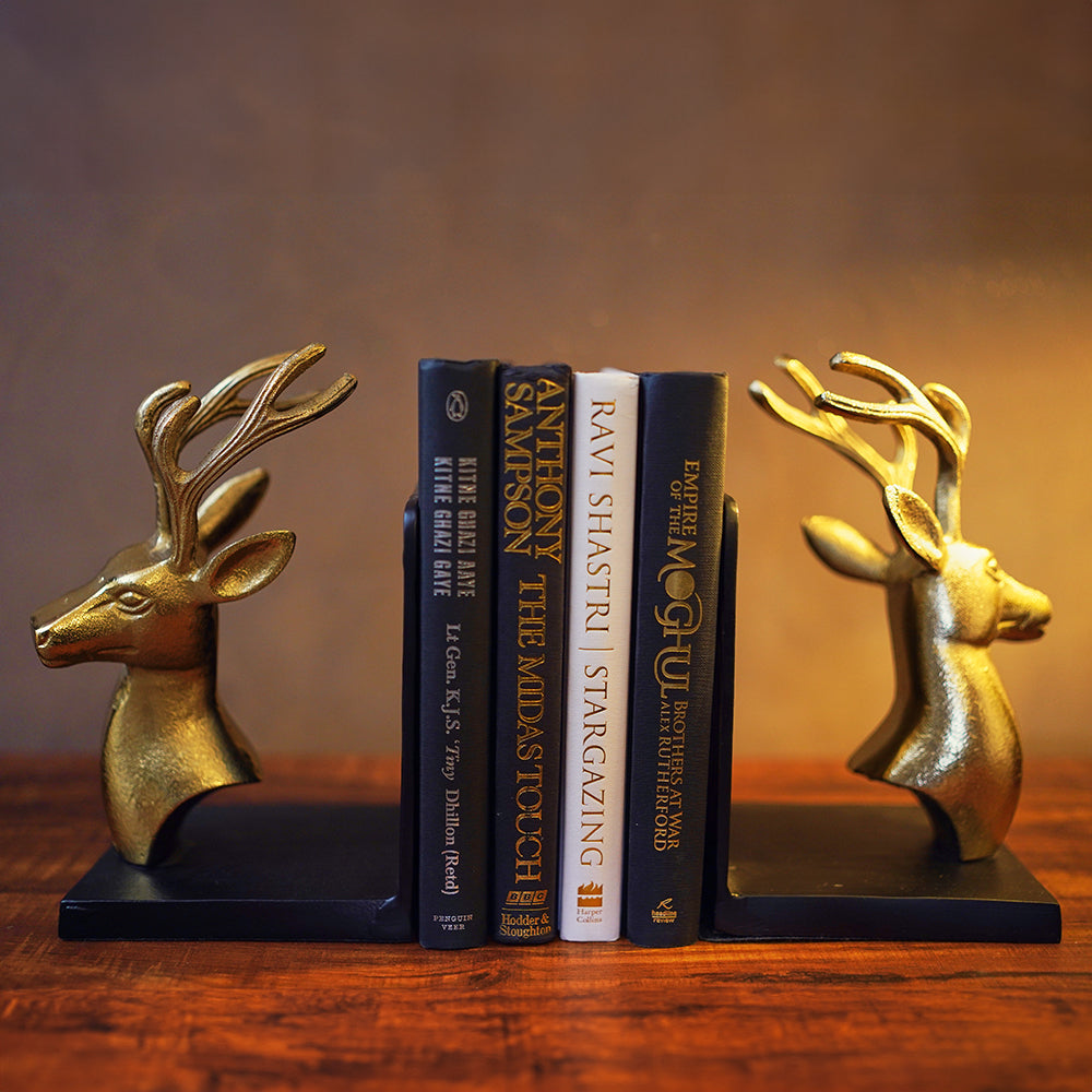 Bookends set of 2 in golden metallic deer head and antlers design with 4 books in between in a front view.