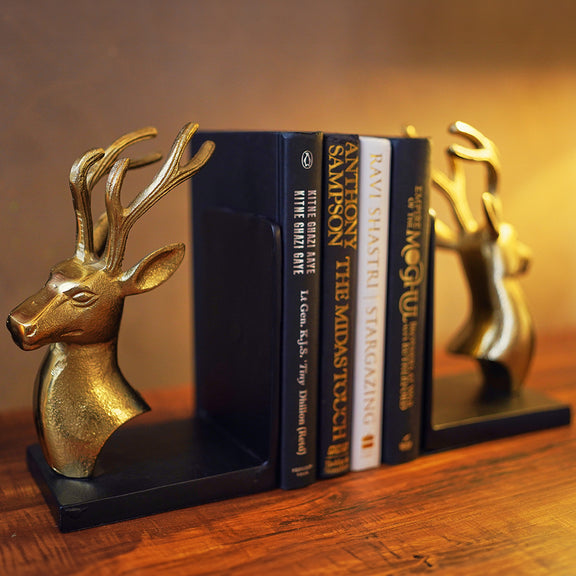 Bookends set of 2 in golden metallic deer head and antlers design with 4 books in between at a side angle.