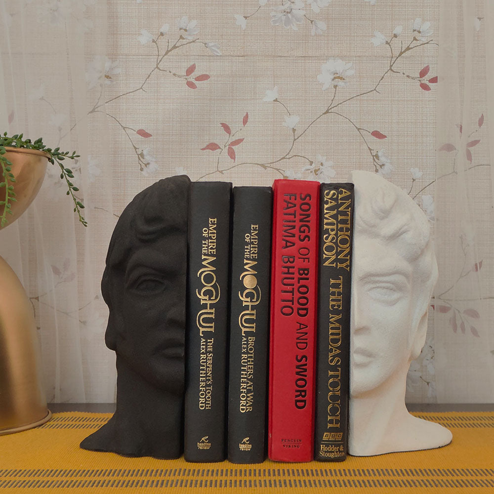 Modern bookends set with a man's face split in half, black and white color with 4 books in between.