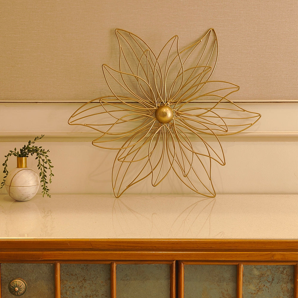 Large golden metallic flower placed on a console table.