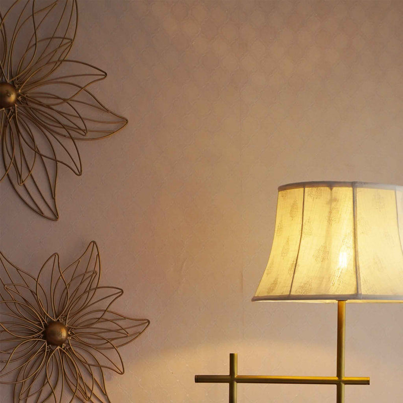 Golden metal floral wall art with a lit-up lamp.