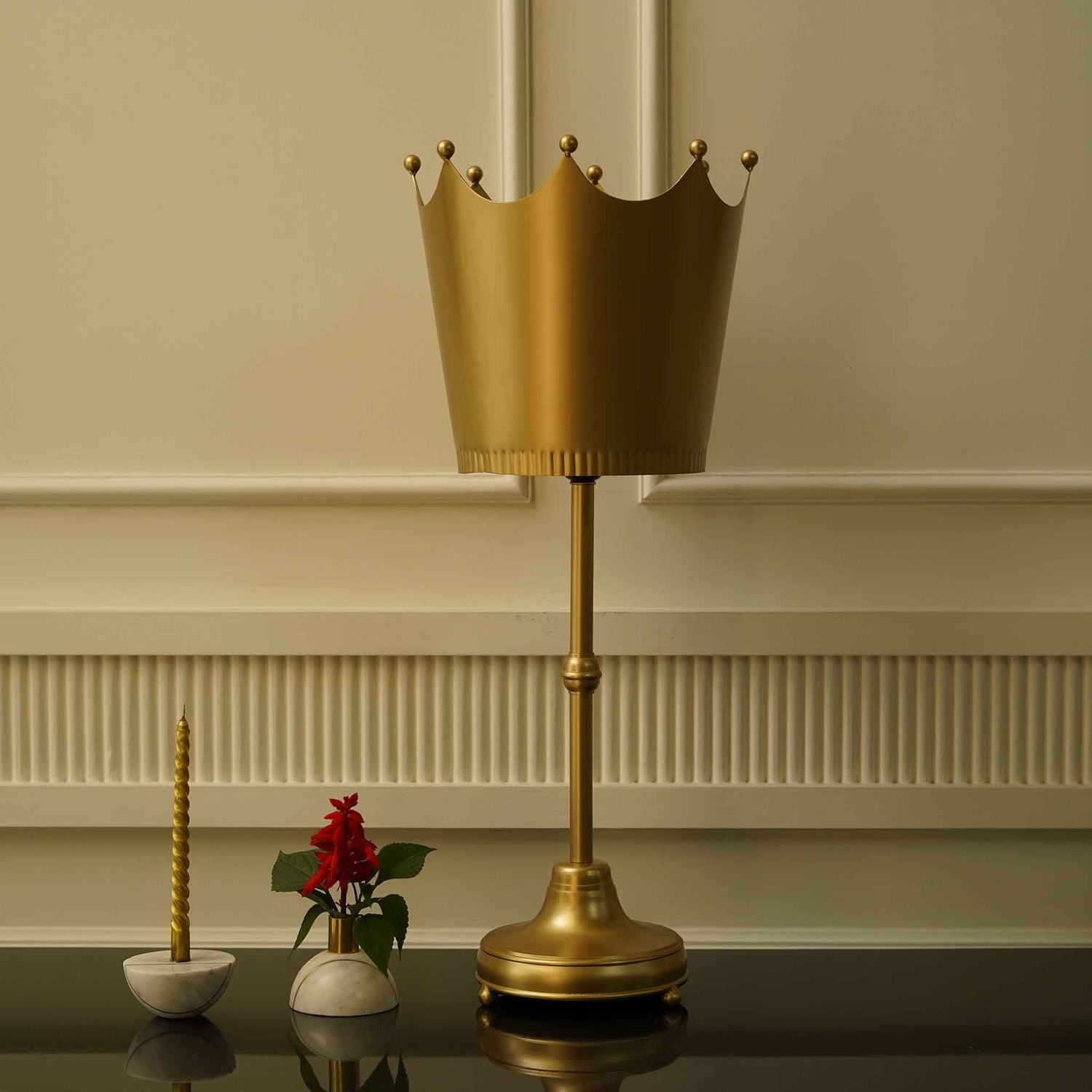 Imperial design golden metallic table lamp with a crown shaped shade.