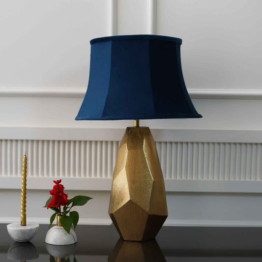 Golden color metallic textured table lamp with blue lamp shade.