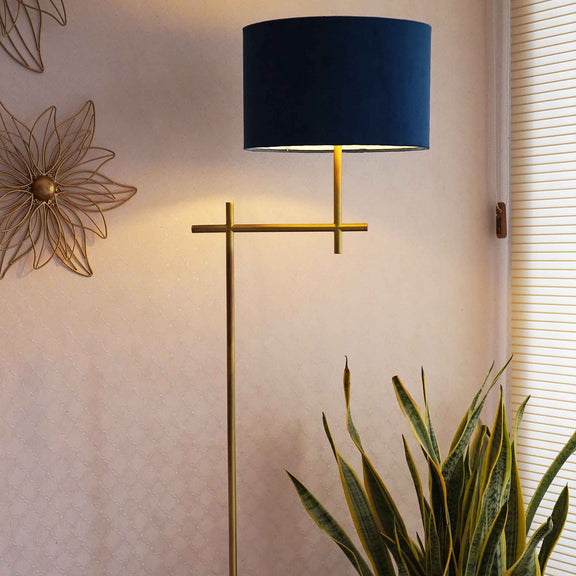 Tall, minimalistic design golden floor lamp with blue shade.