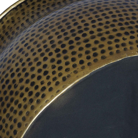 Close-up photo showing antique copper finish and base of a handmade metallic round drum shape coffee table.