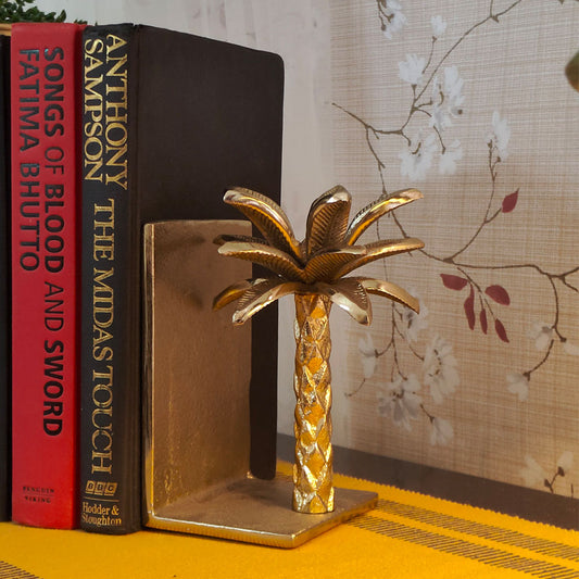 Golden metallic palm tree shaped bookend.