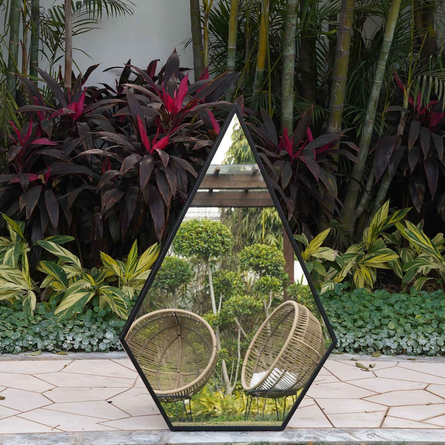 Front view of a tall metallic black pentagon framed mirror.