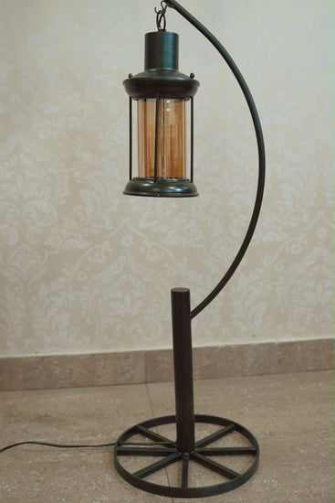 Video of a metallic floor lamp with 2 hanging lanterns