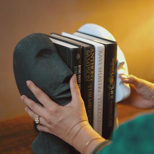 Video of daily usage of face-design bookends with books kept in between.