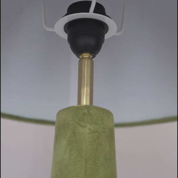Close-up video showing stitching details of velvet on a green floor lamp.