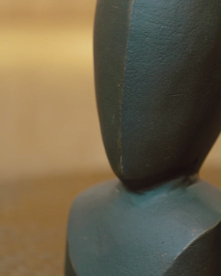 Video of a pair of two black colored abstract faces used for table-top decor shot in various angles placed in a living room.