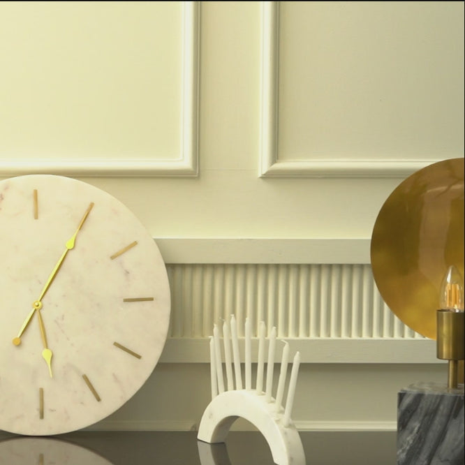 Short video showing a marble clock, candle holder and a concrete base modern table lamp.