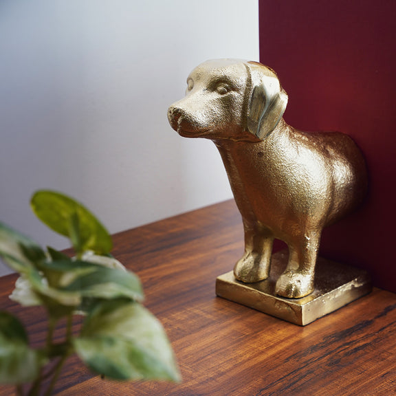 Side angle of one part of a pair of bookends which are in the shape of a dog.