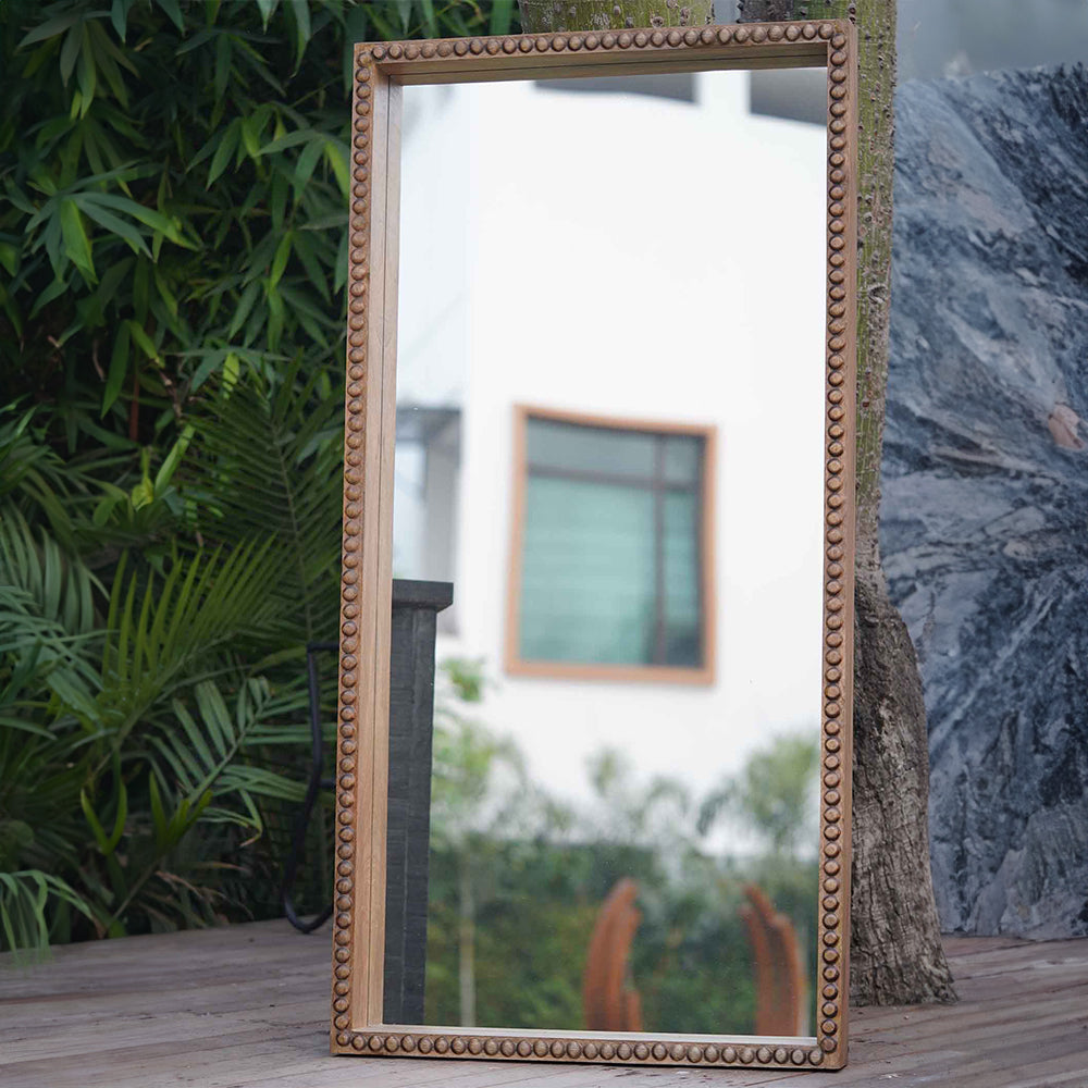 Large floor mirror in hand carved mango wood frame.