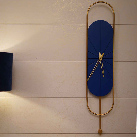 Long blue and golden colored metallic wall clock with pendulum design.