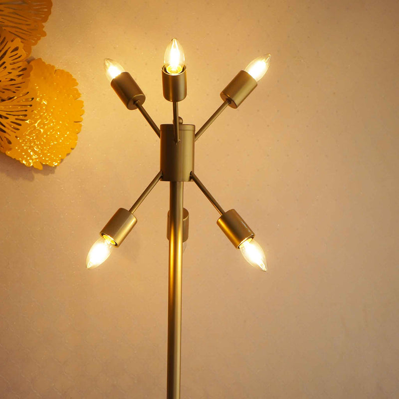 Close-up image of a golden colored modern floor lamp with 6 bulbs lit-up.