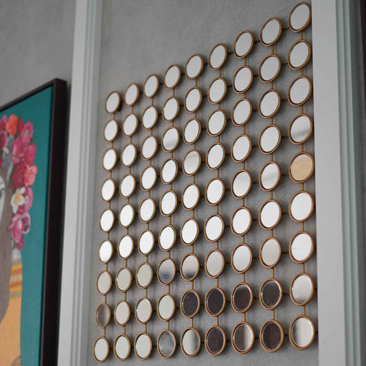 Side view of a modern metallic wall art made of 81 small mirrors.