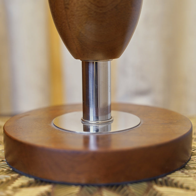 Close up focus image of a wooden lamp showing detailed texture and finish.