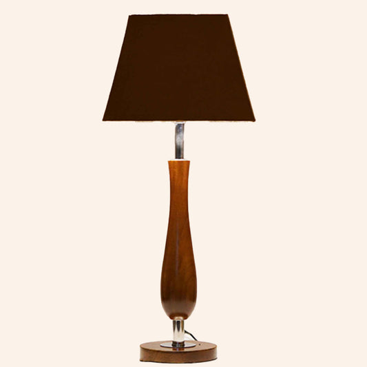 Wooden table lamp with brown shade in a plain background.