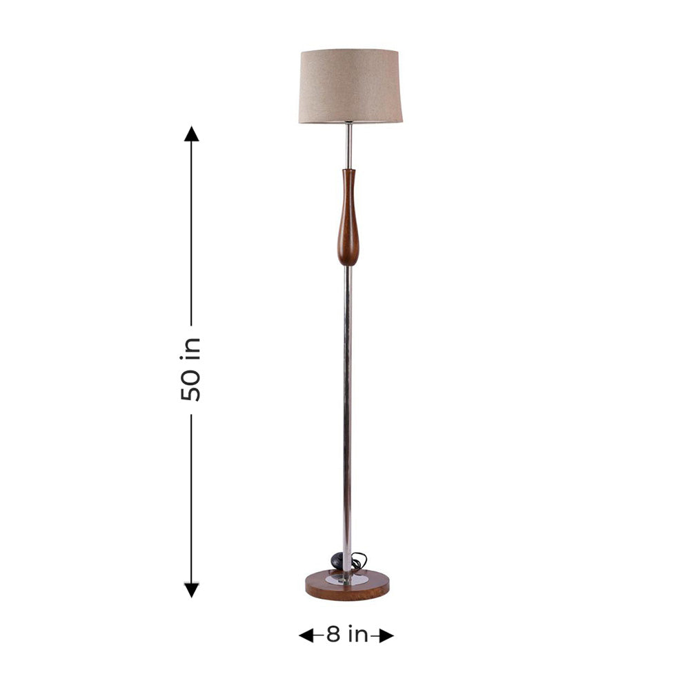 Tall floor lamp in metal and wood in a white plain background.